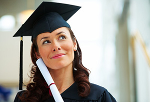 A graduate holding her diploma after completing an IITA program